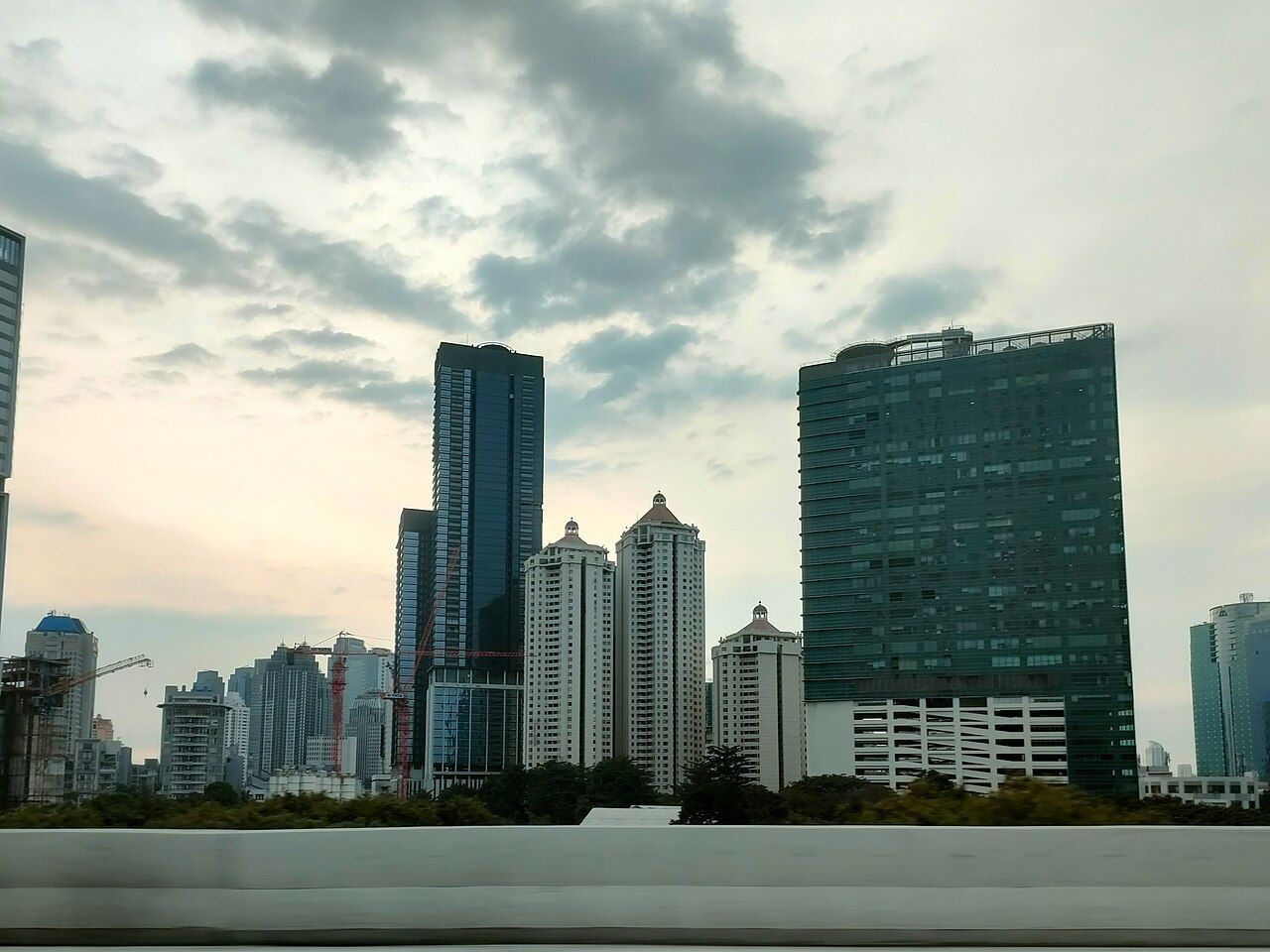 High-rise buildings in South Jakarta under an evening sky.